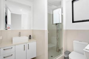 a white bathroom with a shower and a toilet at 2 Welcome To Windsor 2br 2ba Pkg in Perth