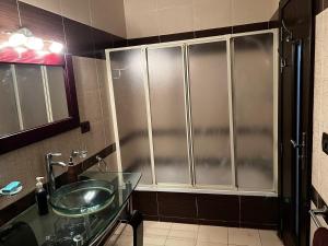 a bathroom with a glass sink and a shower at Luxury Modern Appartment in New Cairo in Cairo