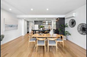 a dining room and kitchen with a table and chairs at The Diggs in Anglesea