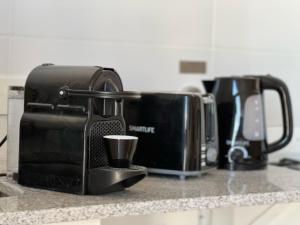 Příslušenství pro přípravu čaje a kávy v ubytování Center Suites Alquiler Temporario