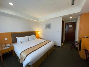 Postel nebo postele na pokoji v ubytování Fuward Hotel Tainan