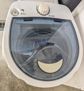 a washing machine with a smile on the front at Shima Stay holoholo in Zamami