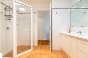 a bathroom with a shower and a sink at 74A Sergeant Baker Drive comfortable duplex with beautiful distant water views in Corlette +25 photos