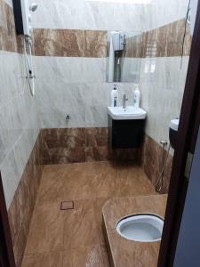a bathroom with a sink and a toilet at D'Rusa Homestay in Port Dickson +14 photos
