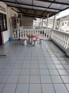 a room with tables and stools in a building at D'Rusa Homestay in Port Dickson