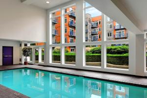 a swimming pool in a building with windows at Belltown Court Space Needle Studio in Seattle