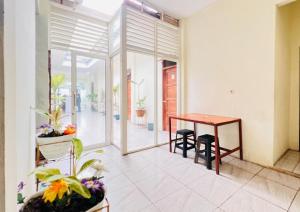 a dining room with a table and some plants at RedDoorz near Alun Alun Sidoarjo in Sidoarjo