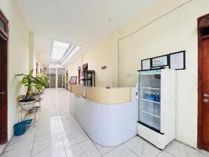 a hallway of a hospital with a refrigerator at RedDoorz near Alun Alun Sidoarjo in Sidoarjo