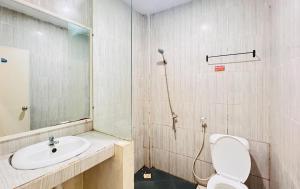 a bathroom with a sink and a toilet and a shower at RedDoorz near Alun Alun Sidoarjo in Sidoarjo