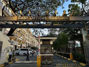 a sign that reads east ottigras mansions over a street at East Ortigas Mansions by MA in Manila