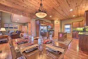 a dining room with a table and a kitchen at Spacious Slaty Fork Home about 12 Mi to Snowshoe in Slaty Fork