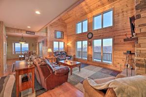 a living room with leather furniture and wood walls at Spacious Slaty Fork Home about 12 Mi to Snowshoe in Slaty Fork