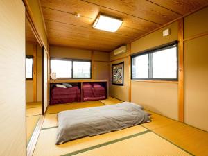 a bedroom with a bed in the middle of a room at Private house Yanagian - Vacation STAY 97777v in Kameoka