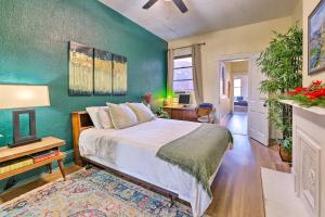 a bedroom with a bed and a green wall at Cincinnati Retreat with Patio and Grill! in Cincinnati