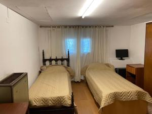 1 dormitorio con 2 camas y ventana en Casa para 6 personas Mar del Plata Barrio Chauvin a 8 cuadras de Guemes en Mar del Plata