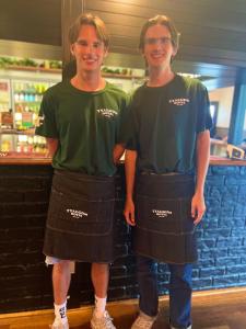 two young men standing in front of a bar at Tyalgum Hotel in Tyalgum