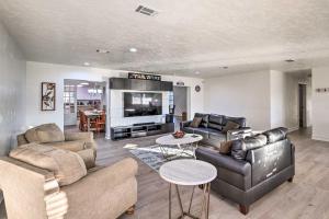 a living room with two couches and a tv at Spacious Family Home w/ Backyard in Gainesville! in Gainesville