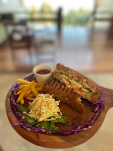 a plate of food with a sandwich and french fries at Timilo Boutique in Tawang