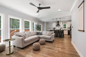 a living room with a couch and a kitchen at New Home, Dock, Home Theatre Projector, Hot Tub, Fire Pit, Kayaks in Winchester