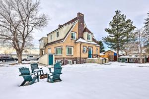 two chairs and a table in the snow in front of a house at Centrally Located Denver Townhome Near Dtwn in Denver