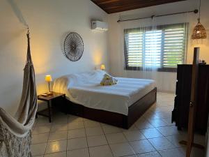 ein Schlafzimmer mit einem Bett, auf dem ein Stofftier liegt in der Unterkunft Casa Pirambu in Pipa + 65 Fotos