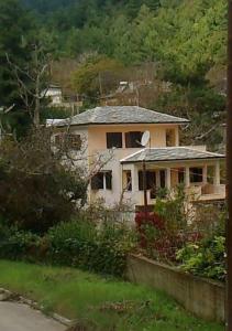 a house that is sitting in the grass at VILLA MALILA in Panayia