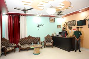 two people standing at the reception desk of a salon at The Forest View Resort in Khilchipur