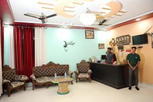 two people standing at the reception desk of a salon at The Forest View Resort in Khilchipur