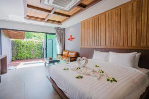 a bedroom with a bed with a swan decoration on it at Malabar Pool Villa Phuket in Phuket Town