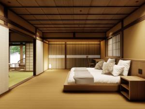 a bedroom with a bed and a balcony at Ryokan Kigusuriya in Nantan city