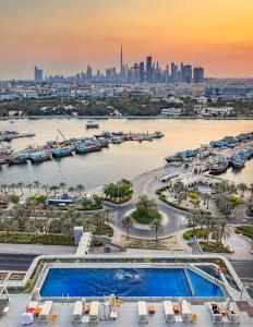 a view of a city and a river with a pool at Al Bandar Rotana – Dubai Creek in Dubai
