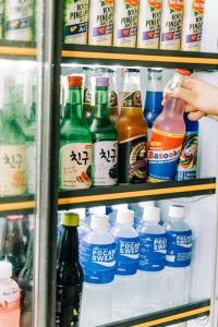 a refrigerator filled with lots of different types of drinks at Family Getaway Dome Glamping w/ Private Hotspring in Lubo