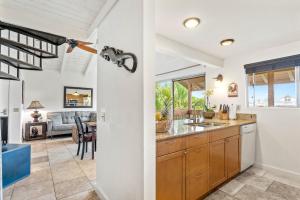 a kitchen with a sink and a living room at Sandpiper 216A condo in Princeville