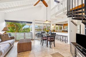 a living room with a couch and a table and chairs at Sandpiper 216A condo in Princeville