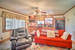 a living room with a couch and a chair at Cozy Lake Charles Studio with Golf Course Views in Lake Charles