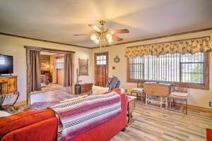 a living room with a couch and a ceiling fan at Cozy Lake Charles Studio with Golf Course Views in Lake Charles