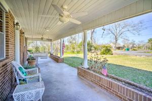 a porch with two chairs and a ceiling fan at Cozy Lake Charles Studio with Golf Course Views in Lake Charles