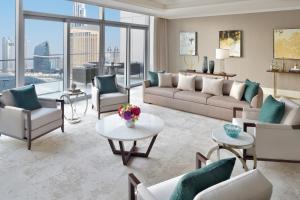 a living room with a couch and chairs and a table at Address Fountain Views in Dubai
