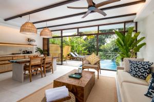 an open living room with a dining room and a kitchen at Ubud Green Resort Villas Powered by Archipelago in Ubud +105 photos