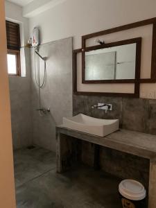 a bathroom with a sink and a mirror at Secret House in Dickwella +135 photos
