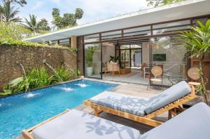 a house with a swimming pool and a patio at Ubud Green Resort Villas Powered by Archipelago in Ubud