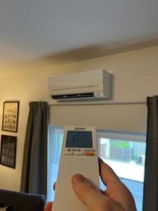 a person is holding a scale in a room at Gemütliches Studio Apartment in Kehl Goldscheuer - 1A Guesthouse in Kehl am Rhein