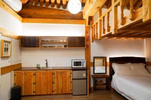 a bedroom with a bed and a sink and a microwave at Samlockhon Hanokstay in Jeonju