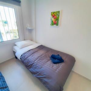 a small bed in a room with a window at Sea Breeze Central, 2bed in Limassol