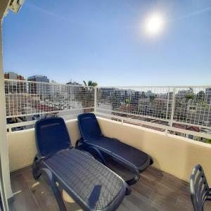 two chairs sitting on top of a balcony at Sea Breeze Central, 2bed in Limassol