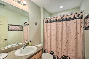 a bathroom with a sink and a shower curtain at Dahlonega Cabin with Hot Tub, 4 Mi to Downtown! in Dahlonega +29 photos