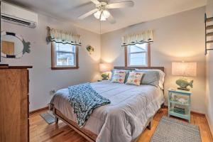 a bedroom with a bed and a ceiling fan at Waterfront Lakeview Cottage with Dock and Lift! in Lakeview