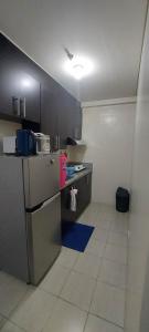 a kitchen with a stove and a counter top at Rochester Condo in Manila