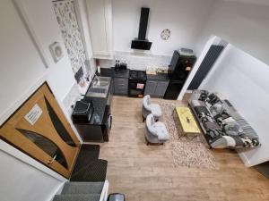 an aerial view of a living room with a couch and a stove at Cheerful 4 bedroom close to Uclan, Preston City Center in Preston