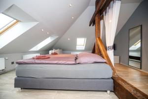 a bedroom with a bed in a attic at Libušina Villa in Kutná Hora